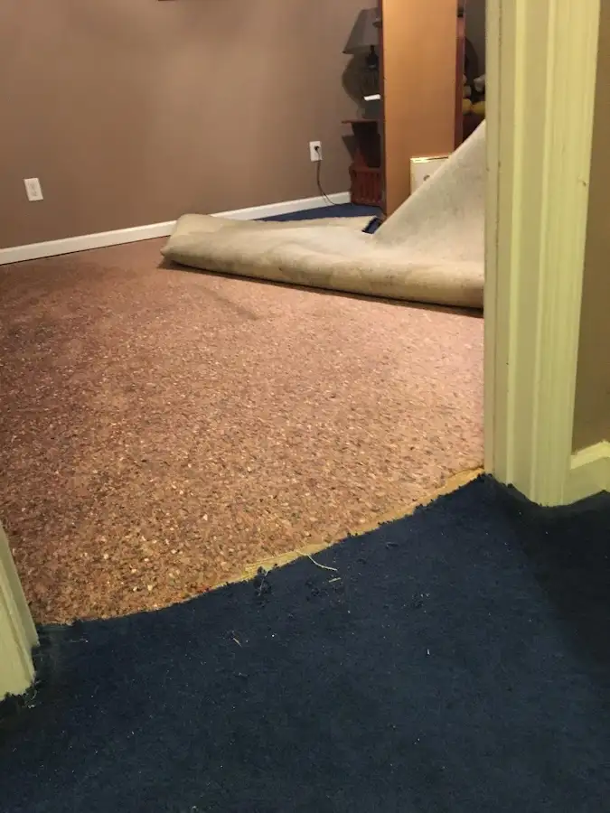 Carpet pad removal revealing water damage during Water Mitigation Services in Wagoner